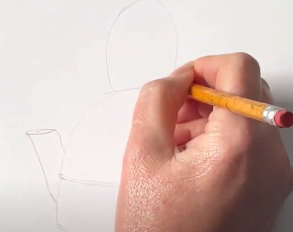 Someone sketching a tea cosy design