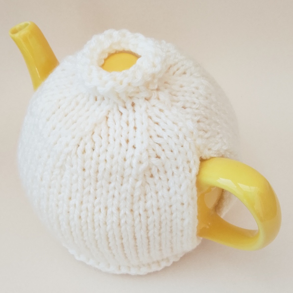 Simple knitted tea cosy on a teapot, representing the National Tea Cosy Day article