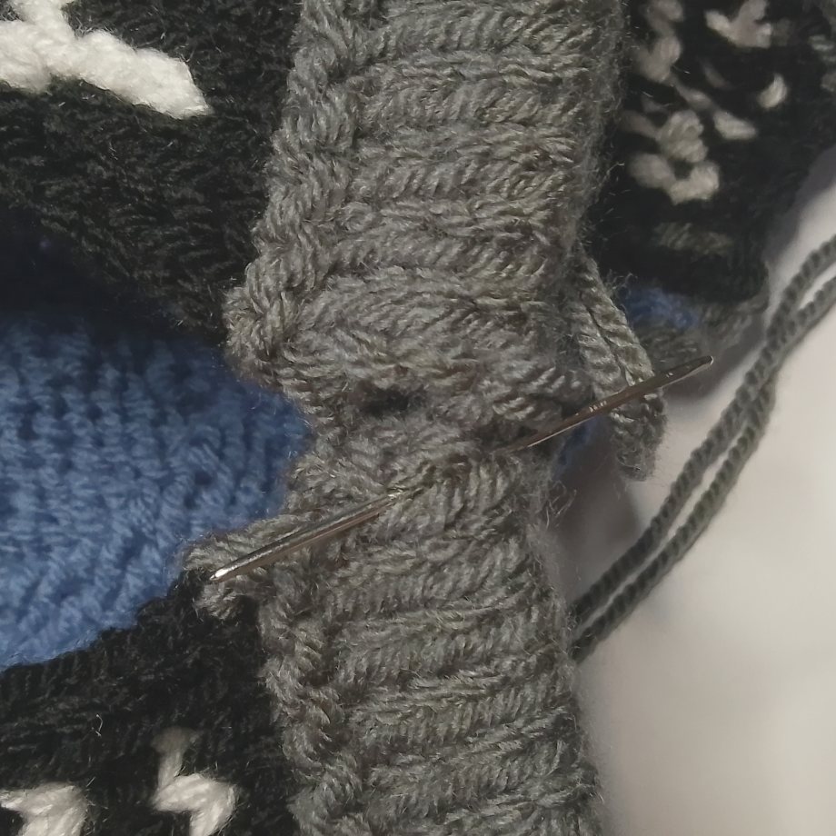 Mattress stitch tutorial step 1 inserting needle into first row end edge of tea cosy